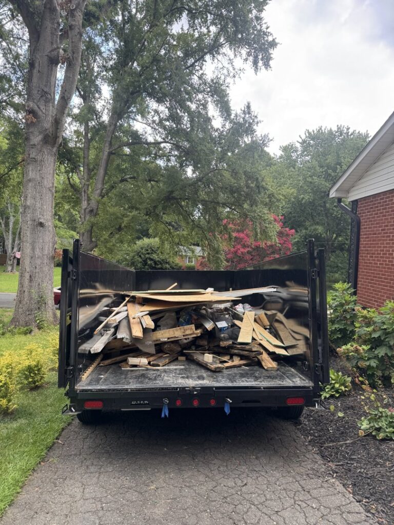 A dump trailer filled with wood and construction debris from a junk removal job by Junkjet in Charlotte, NC.
