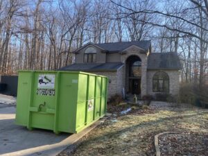 A Bin There Dump That green dumpster on a residential property, ideal for general junk removal in Indianapolis, IN.