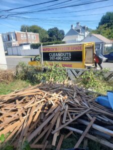 A Space Erasers Junk Removal employee loading wood debris into a truck during a cleanout job in Philadelphia, PA