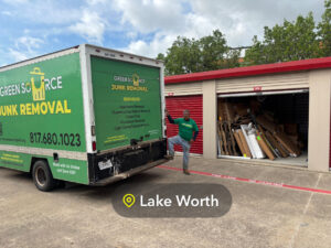 A Green Source Junk Removal employee standing by a truck next to a storage unit filled with junk in Fort Worth, TX.