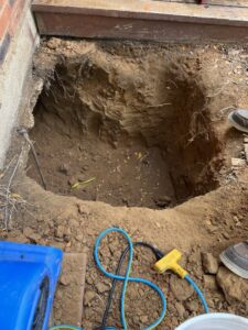 A large excavation pit for underground plumbing repair by Molberg Plumbing in Ft Worth, TX