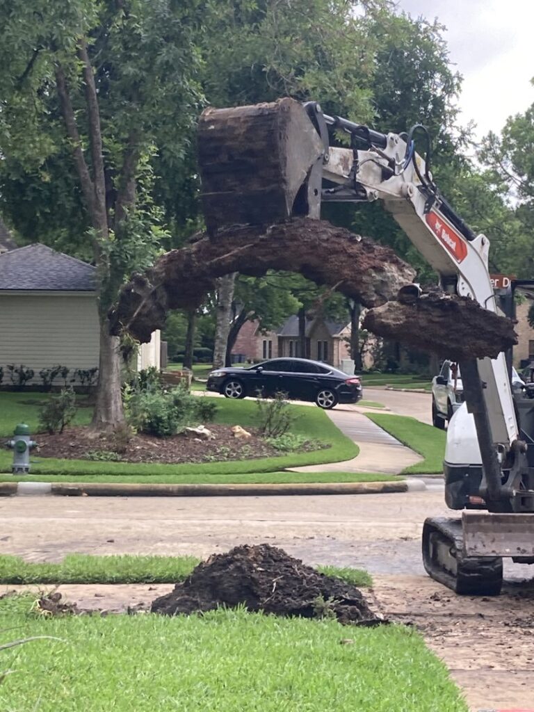 An excavator removing a large tree stump during a land clearing job by Right On Time Junk Removal in Houston, TX.