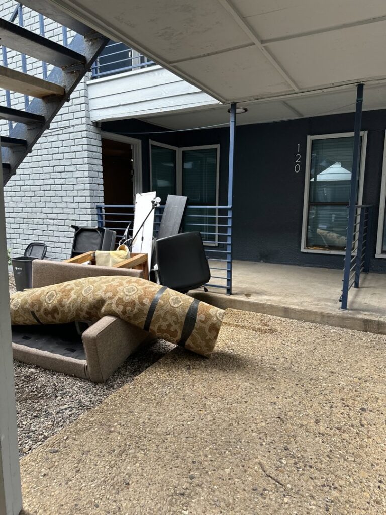Discarded furniture and other items piled outside an apartment building, awaiting removal by Perez Junk Removal in Anaheim, CA.