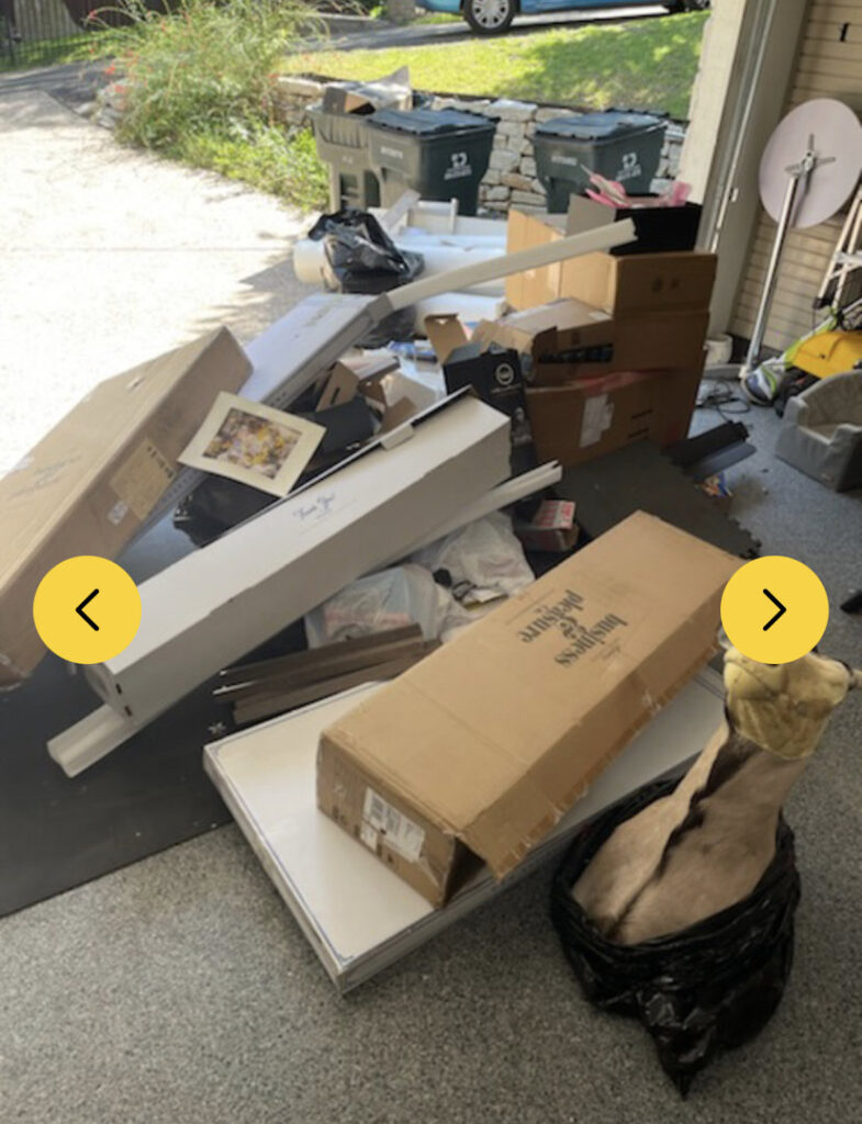A cluttered garage with boxes and various items piled up, awaiting junk removal service from IHaul Austin in Austin, TX.