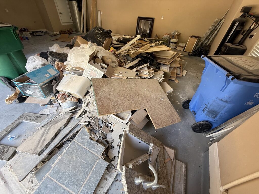 A garage filled with construction debris, old fixtures, and general junk, ready for JunkGuys Austin Junk Removal service in Austin, TX.