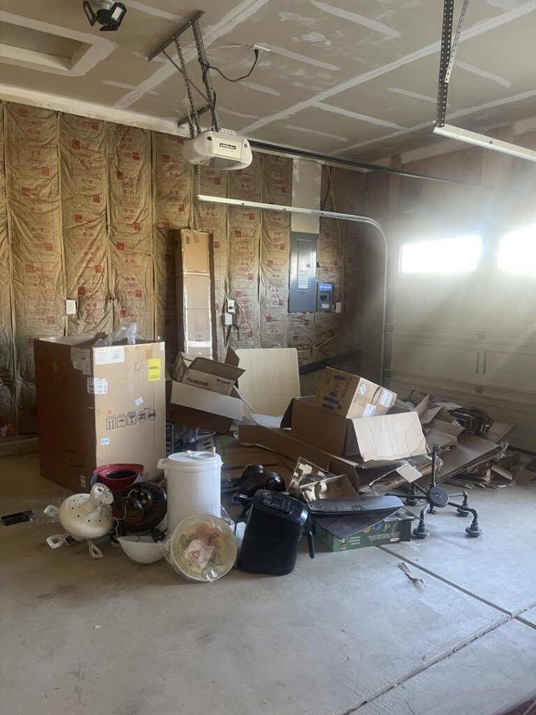 A garage full of boxes and debris, ready for cleanup and removal by Indy Trash Guy in Fortville, IN.