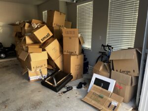 A garage filled with numerous cardboard boxes, ready for removal by Handymen Junk Removal in Houston, TX.