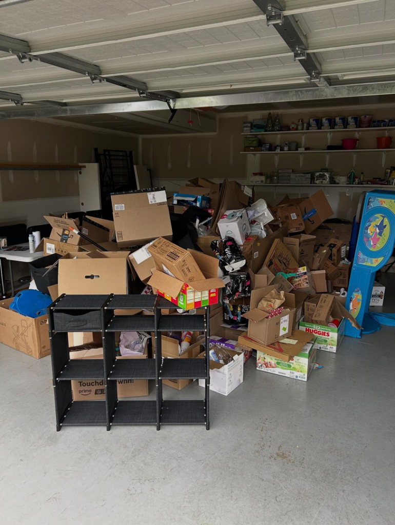 A garage filled with numerous cardboard boxes and miscellaneous items, ready for junk removal by Nolen's Junk Removal in Feasterville-trevose, PA.