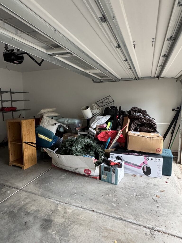 A garage filled with various household junk items before removal by Junkjet in Charlotte, NC.