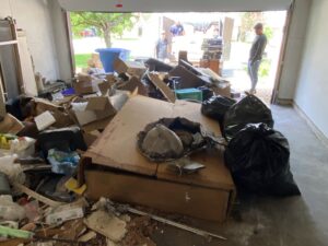 A garage filled with various items and junk awaiting removal by Texas Strong Hauling and Junk Removal in San Antonio, TX.
