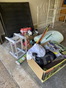 A garage filled with various household junk items ready for removal by IHaul Austin in Austin, TX.