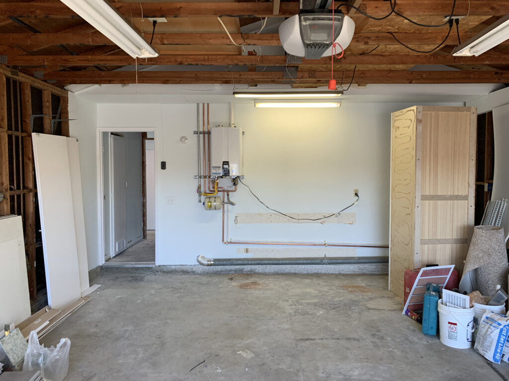 A tankless water heater installation with new copper piping in a garage by JG Water Heaters, Filtration and Plumbing in San Diego, CA