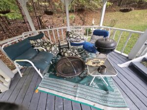 A gazebo filled with old outdoor furniture, a fire pit, and a grill, ready for junk removal by Purefoy's Professionals in Columbus, OH.