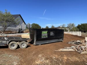 A G.I. HAUL dumpster on a trailer ready for construction debris removal in Austin, TX.