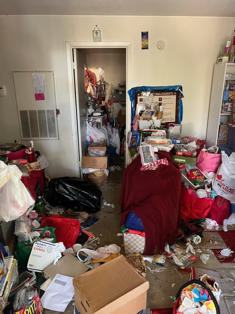 An extremely cluttered room, indicative of a hoarder cleanout, requiring extensive junk removal by IREP Junk Removal ATX in Austin, TX.