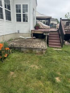 A large pile of household junk, including boxes and a filing cabinet, placed curbside for pickup by High Speed Junk Removal in Levittown, PA.