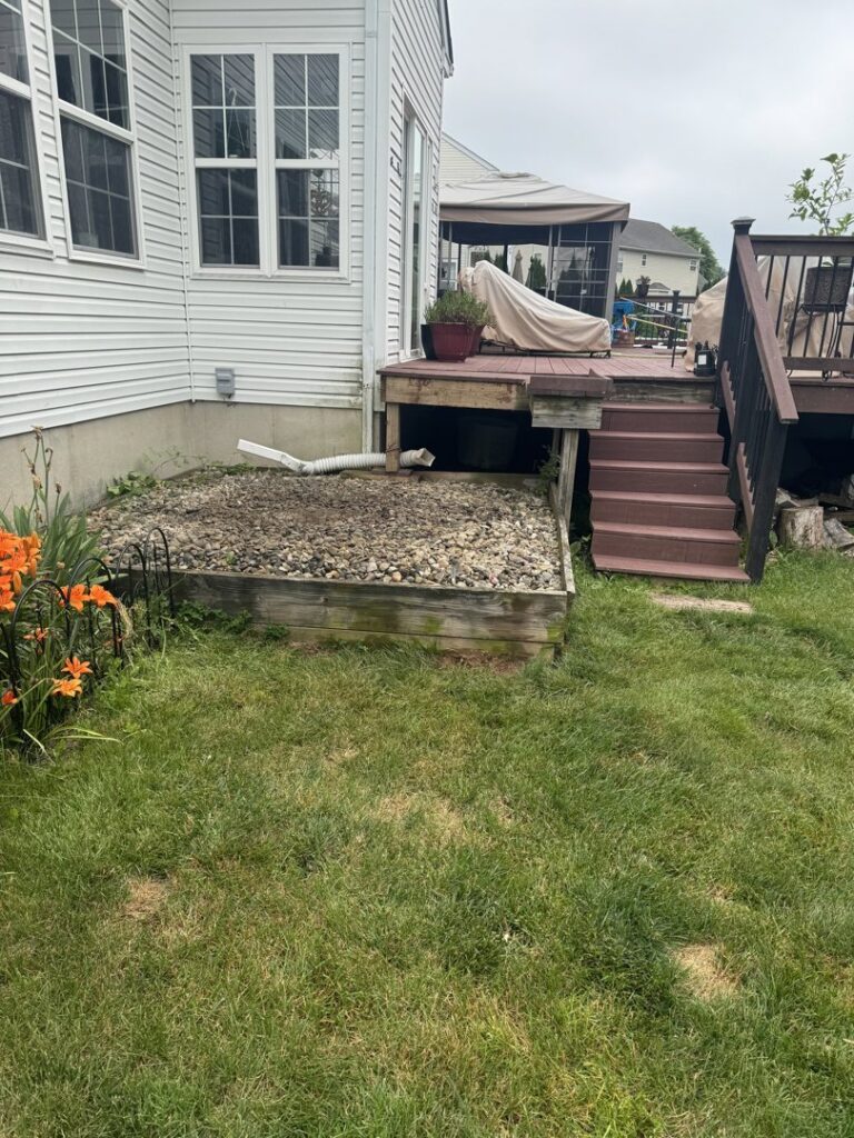 A large pile of household junk, including boxes and a filing cabinet, placed curbside for pickup by High Speed Junk Removal in Levittown, PA.