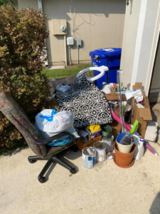 A pile of household junk including an office chair, pillows, and paint cans, ready for removal by Jax Junkies Removal LLC in Jacksonville, FL
