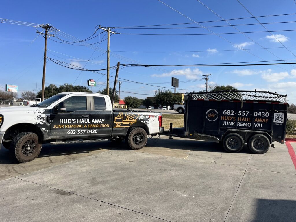 The Hud's Haul Away Junk Removal & Demolition truck and trailer parked on a street in Fort Worth, TX.