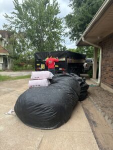 Large bags of insulation ready for pickup by Speedy Junk Removal & recycling from a home in Houston, TX.