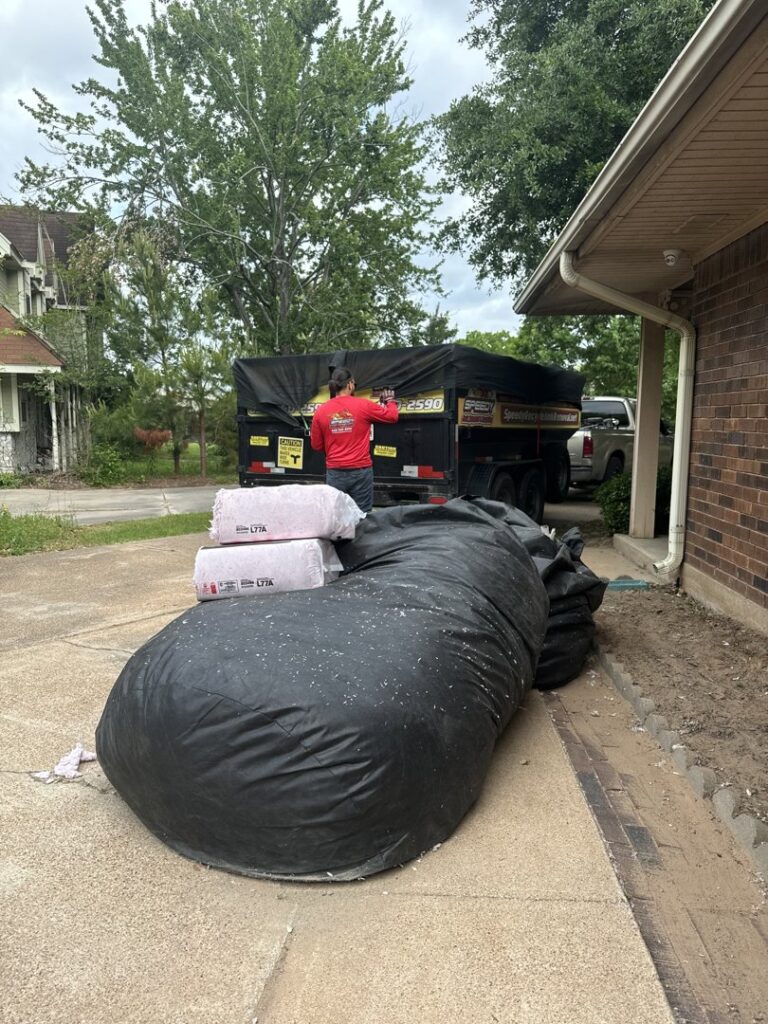 Large bags of insulation ready for pickup by Speedy Junk Removal & recycling from a home in Houston, TX.