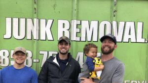 A Jake's Junk Removal truck fully loaded with various debris and household items in San Diego, CA.
