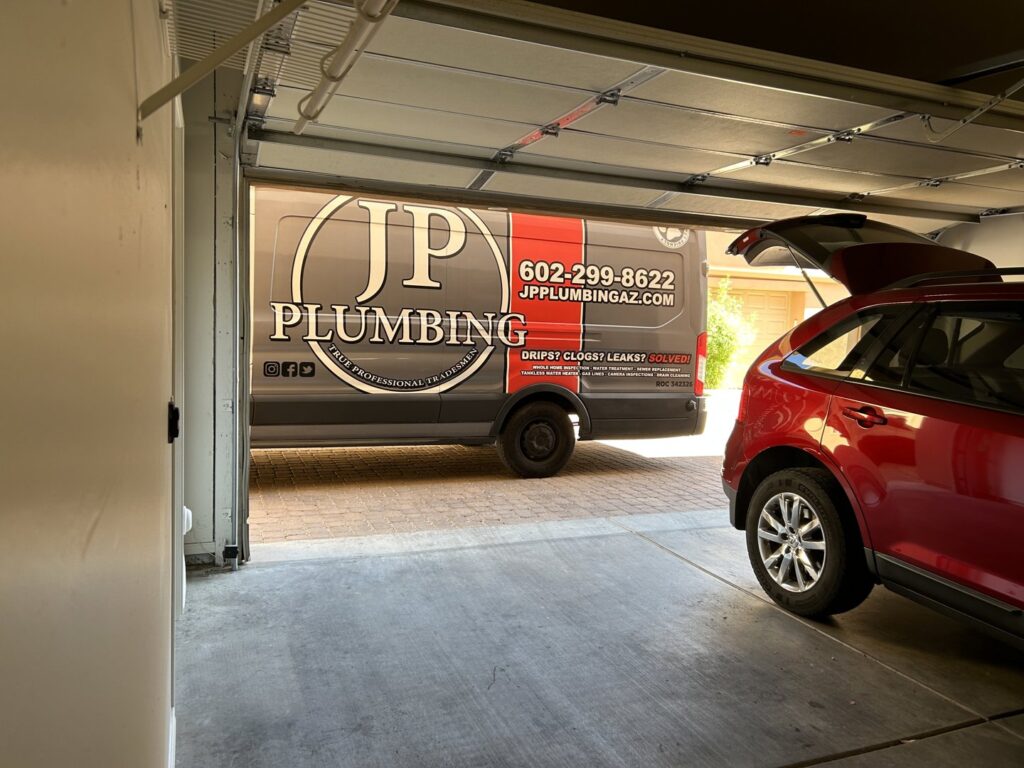 A JP Plumbing service van with a large jetting trailer for advanced drain and sewer cleaning services in Phoenix, AZ