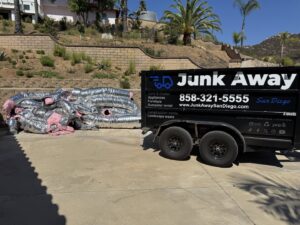 A Junk Away - San Diego truck dumping a load of general junk and trash at a disposal facility in San Diego, CA.