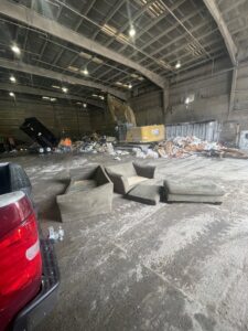 An interior view of a junk disposal site with furniture, showing the end process of Kay's Brothers Junk Removal in Philadelphia, PA.