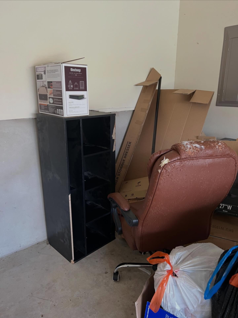 A pile of junk including a damaged office chair, shelving unit, and boxes ready for removal by Yellowstone Junk Removal in San Antonio, TX.