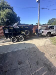 A Haulaway Junk Removal Service, LLC truck and trailer loaded with debris during a junk removal job in Dallas, TX.