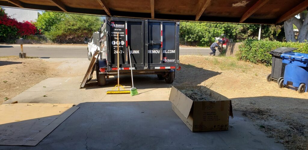 A 24/7 Junk Removal trailer parked for a yard waste pickup job in Rolling Hills Estates, CA.