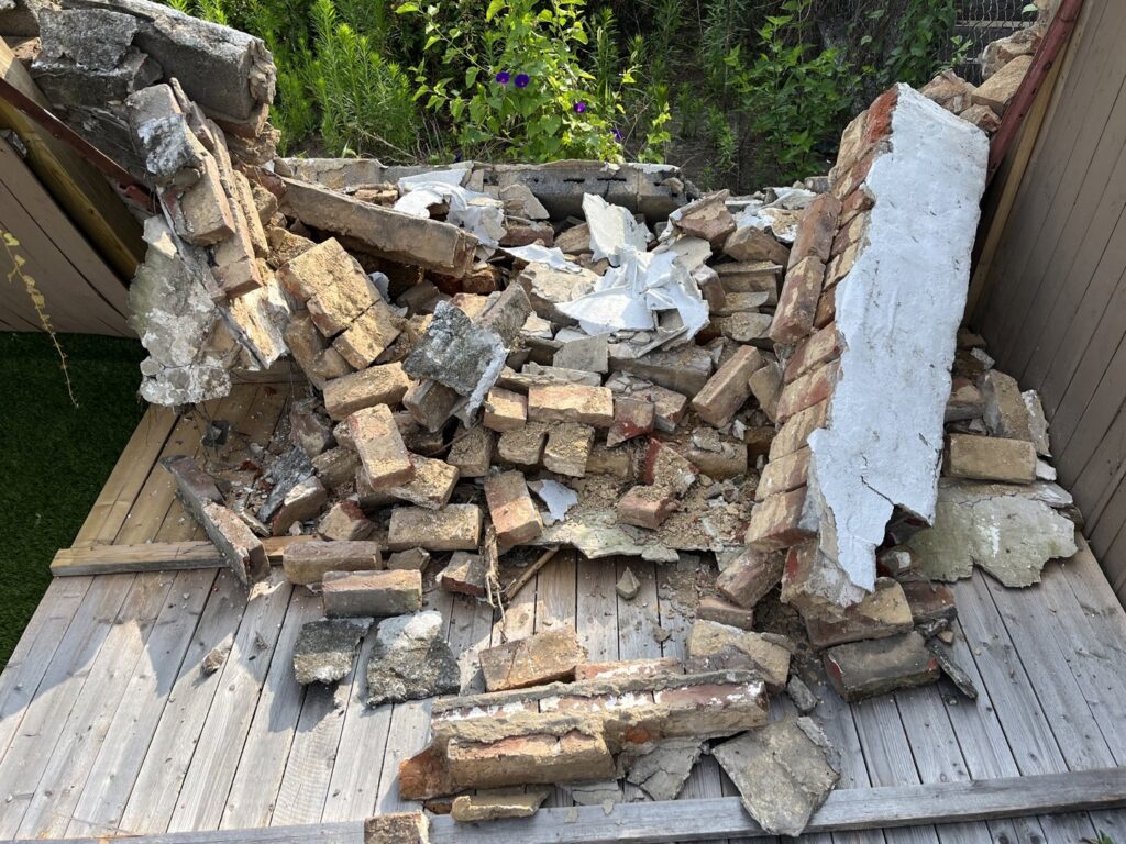 A We Love Junk truck delivering a dumpster for a junk removal job in Philadelphia, PA.