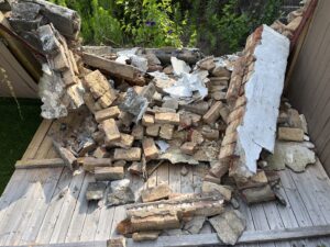 A We Love Junk truck delivering a dumpster for a junk removal job in Philadelphia, PA.