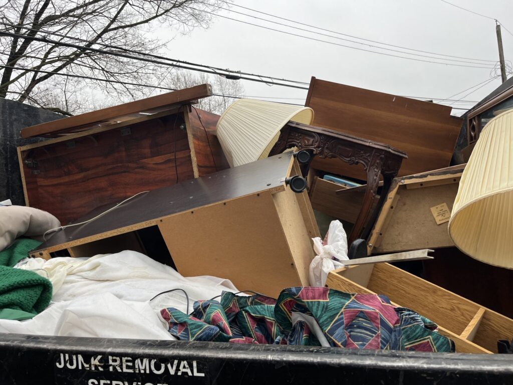 A junk removal truck filled with old furniture, lamps, and household items by Lug Stars Junk Removal in Columbus, OH.