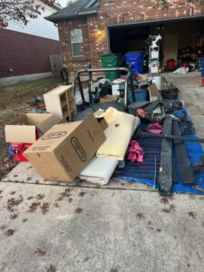 The back of a 1-800-JUNKPRO junk removal truck loaded with wooden debris in Austin, TX.