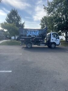 A branded junk removal truck from Two Men and a Junk Truck parked on a street in Columbus, OH, ready for service.