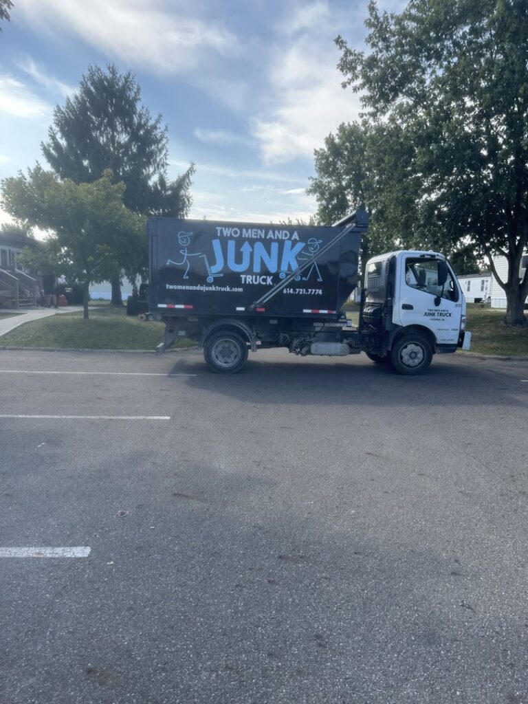 A branded junk removal truck from Two Men and a Junk Truck parked on a street in Columbus, OH, ready for service.