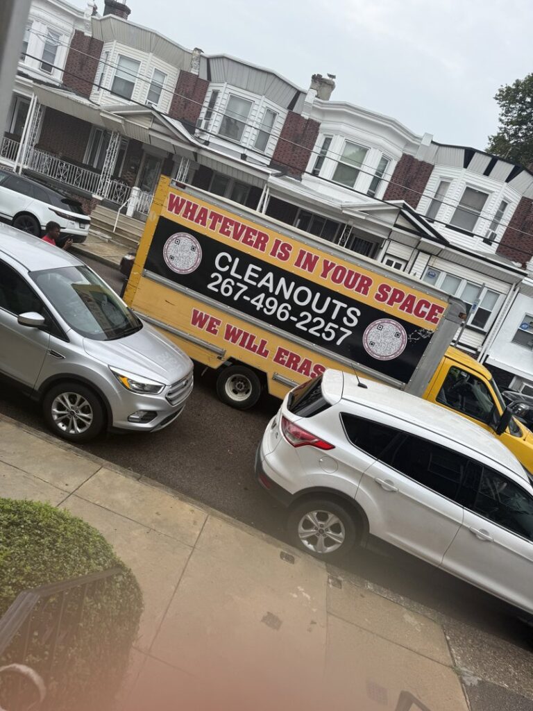 A Space Erasers Junk Removal truck parked on a residential street in Philadelphia, PA, ready for a job