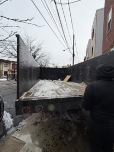 A GEF Hauling and Junk Removal truck with debris in the back, ready for a job in Philadelphia, PA.