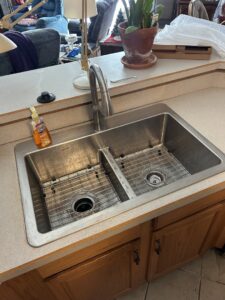 A newly installed kitchen sink faucet by Apex Pros Plumbing, Electric, Heating, and Air in Columbus, OH.