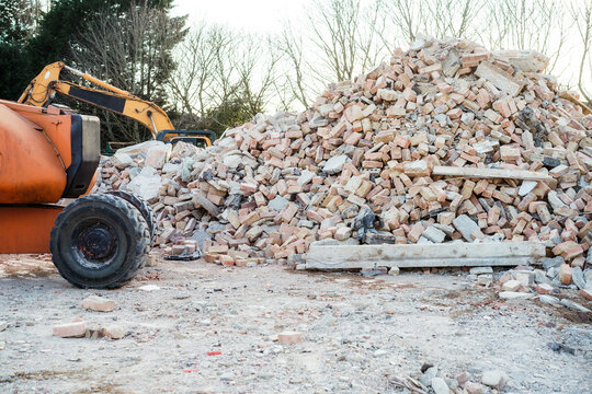 A large pile of bricks and concrete rubble at a demolition site, indicating debris removal services by Epic Junk Removal SD in San Diego, CA.