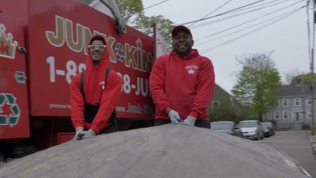 A large pile of household junk, boxes, and bags on a driveway, ready for removal by Junk King San Antonio Northwest in San Antonio, TX.