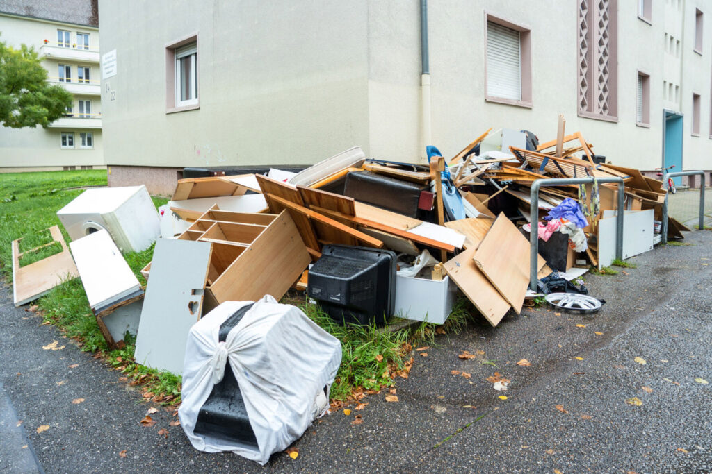 A large pile of various household junk, including furniture and electronics, accumulated outdoors for removal by Zen Junk in San Jose, CA.