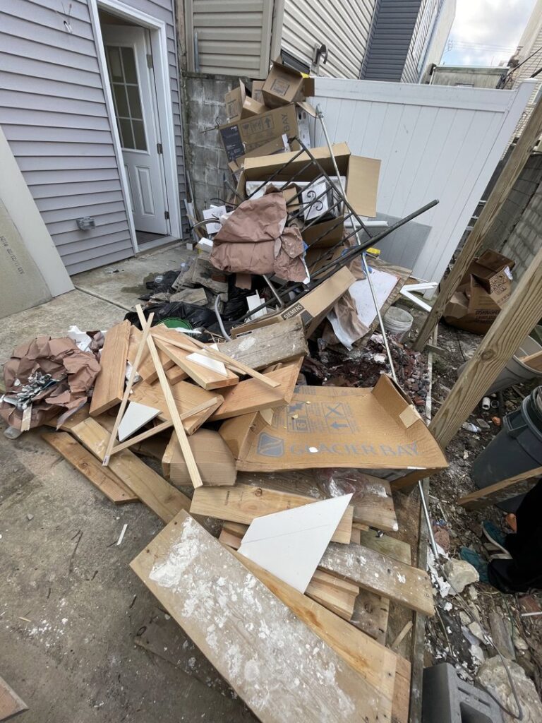 A large pile of residential junk and construction debris, including cardboard, wood, and metal, ready for removal by JPC Junk Removal & Demolition in Philadelphia, PA.