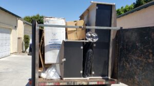 A loaded junk removal trailer with boxes and furniture from a job by 24/7 Junk Removal in Rolling Hills Estates, CA.