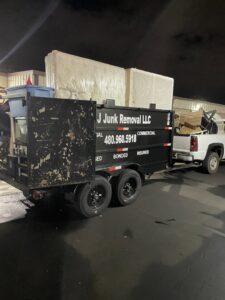 A Cee J Junk Removal LLC trailer loaded with mattresses and other items after a job in Phoenix, AZ.