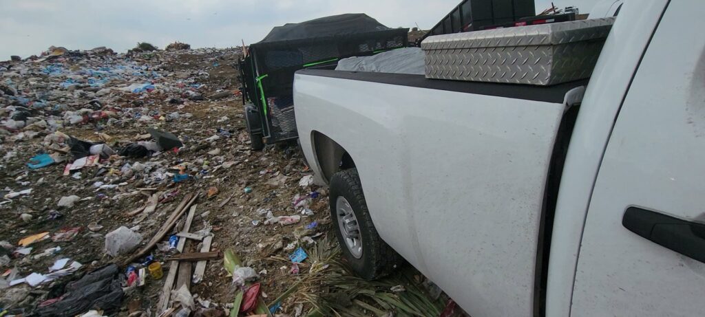 A junk removal trailer loaded with furniture and debris in a residential driveway by Your Junk My Trunk Junk Removal in San Antonio, TX.