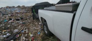 A junk removal trailer loaded with furniture and debris in a residential driveway by Your Junk My Trunk Junk Removal in San Antonio, TX.