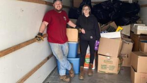 Master Junkers crew members loading a truck with boxes and trash bags during a junk removal job in Powell, OH.